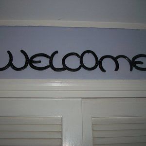 "Welcome" sign made with horse shoes - man made